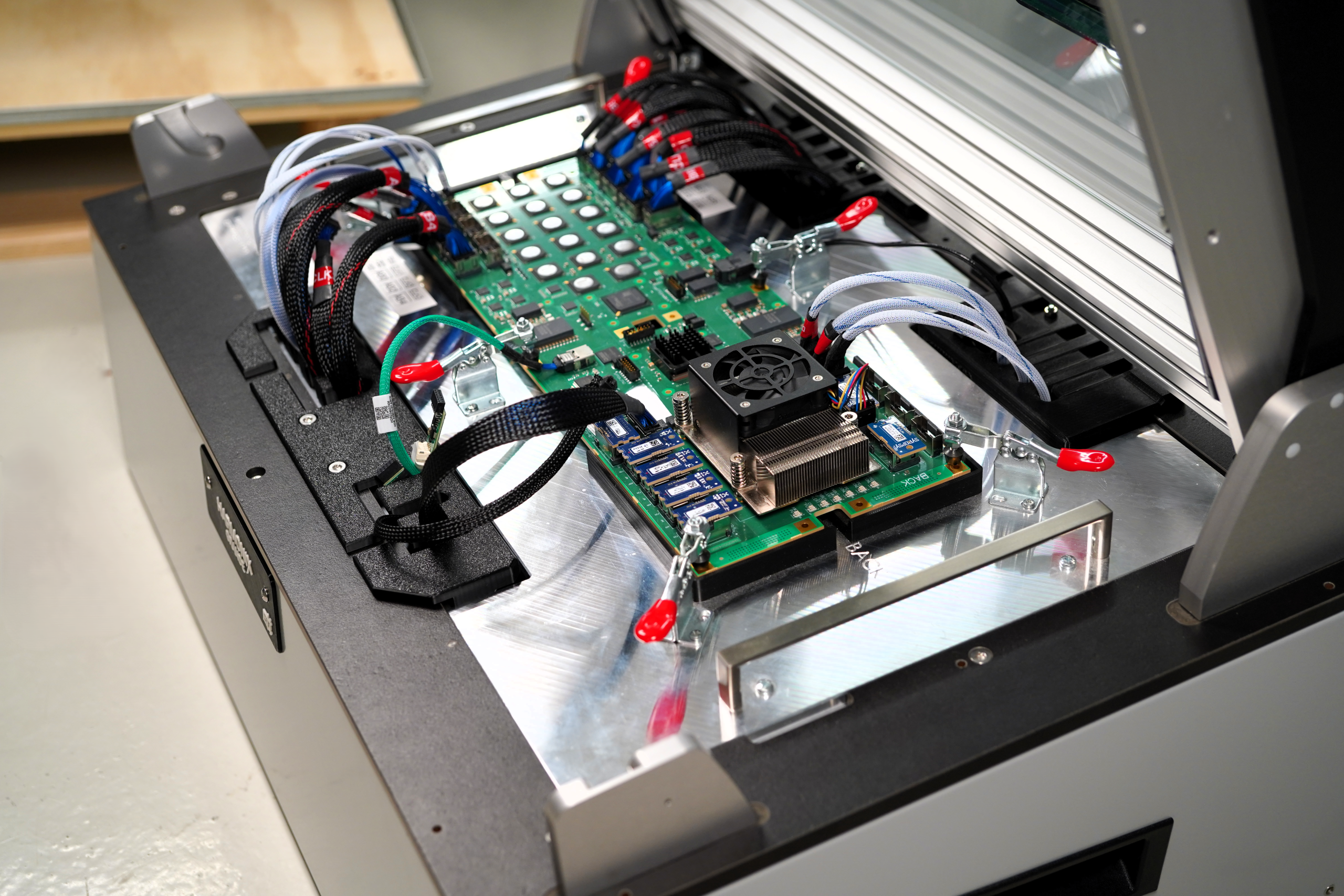Custom Harmonix top plate contacting a PCB with adapter cards and wiring