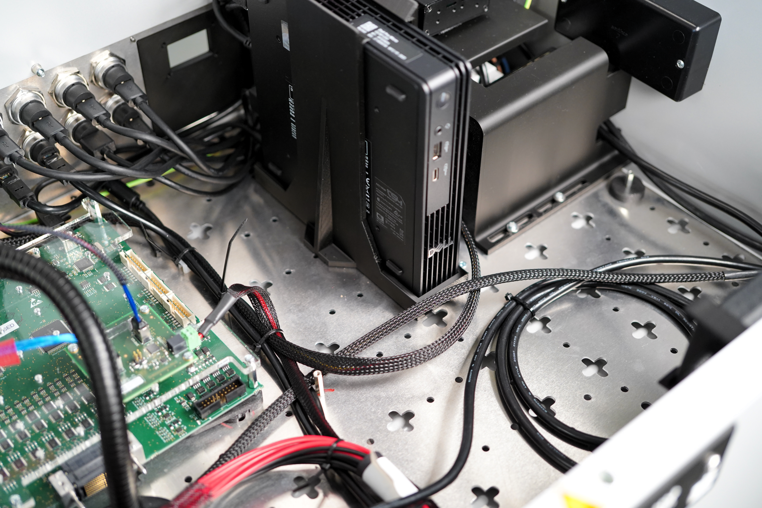 Inside a Harmonix fixture — built-in PC and adapter cards wired to the test interface